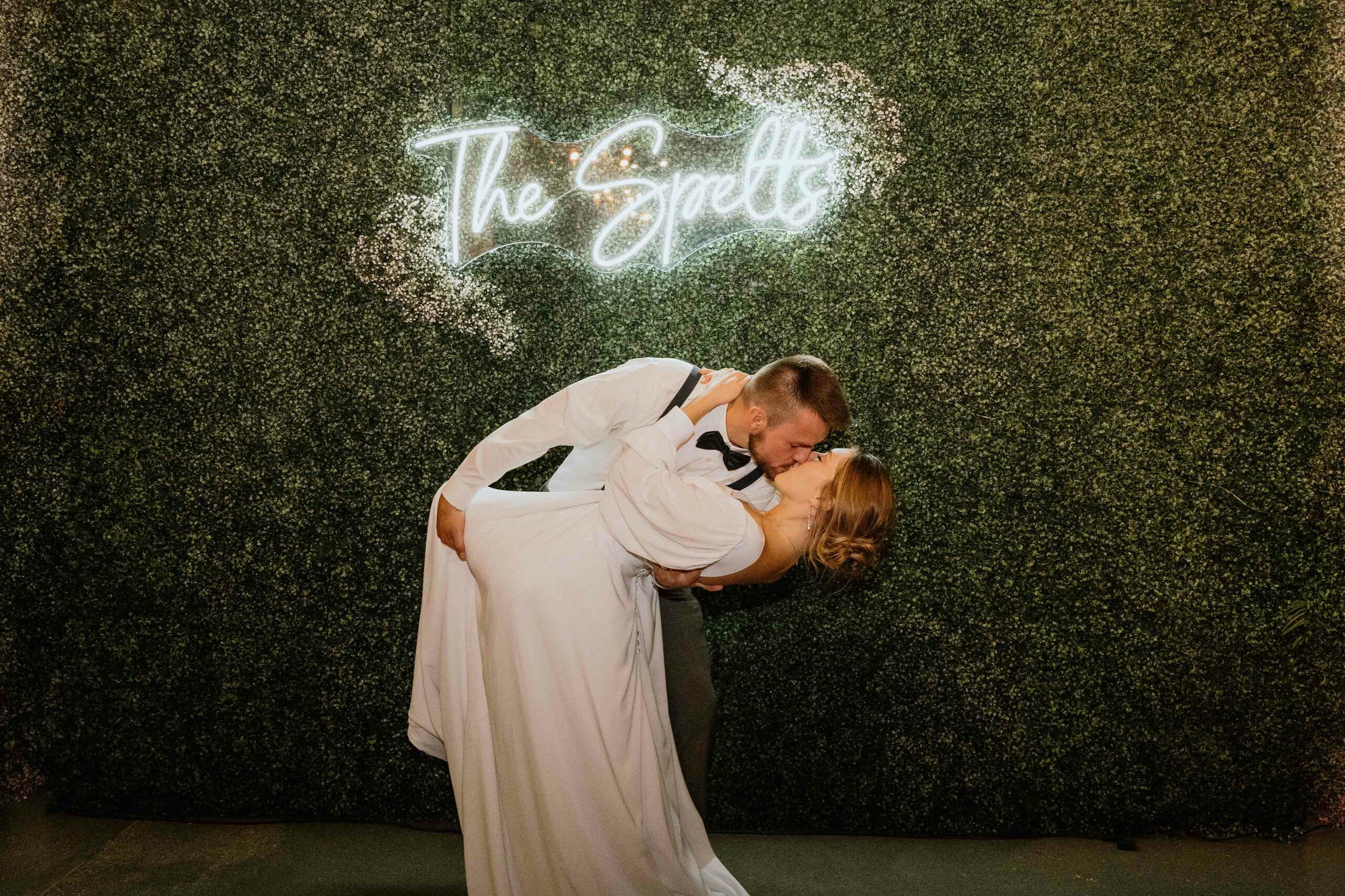 Wedding couple kissing at The Garden Room in Omaha, Nebraska great detail photo with green background