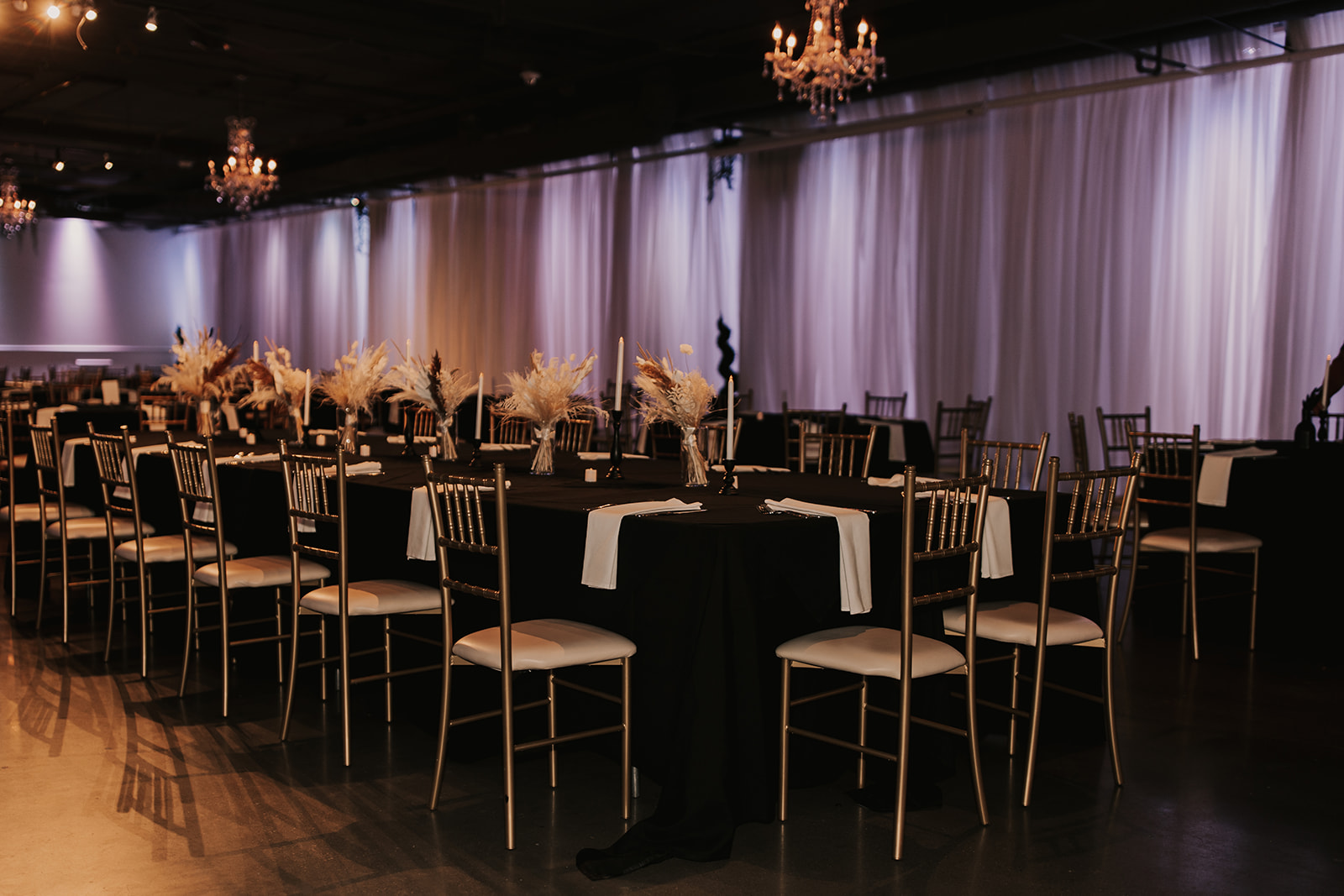 The Garden Room reception space showing off tables and uplighting in Omaha