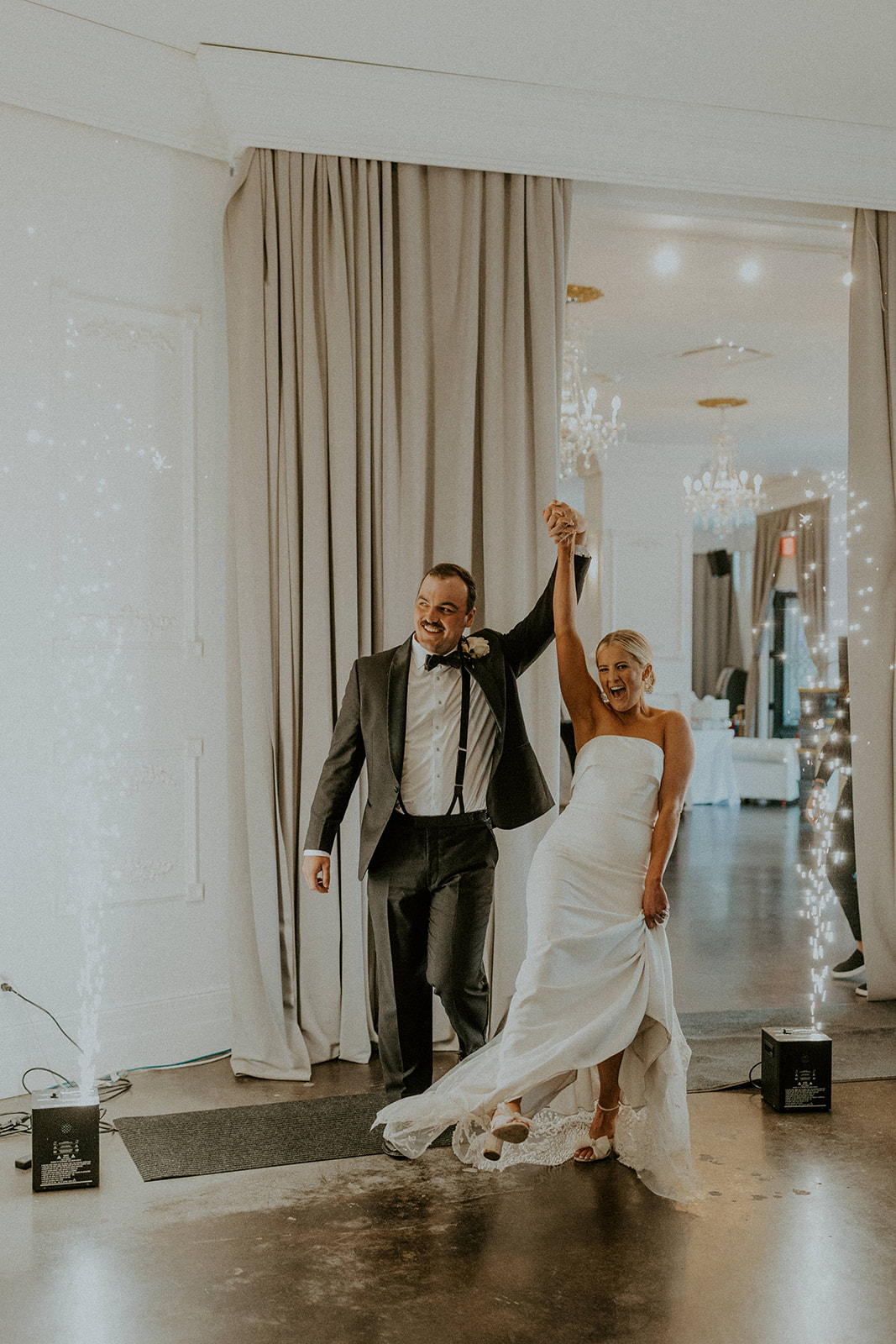 Wedding couple walking into the reception holding hands beautiful shot of wedding couple